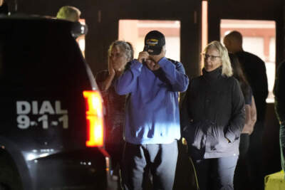 People depart a reunification center early Thursday, Oct. 26, 2023, at Auburn Middle School, in Auburn, Maine, after shootings in Lewiston. (AP Photo/Steven Senne)