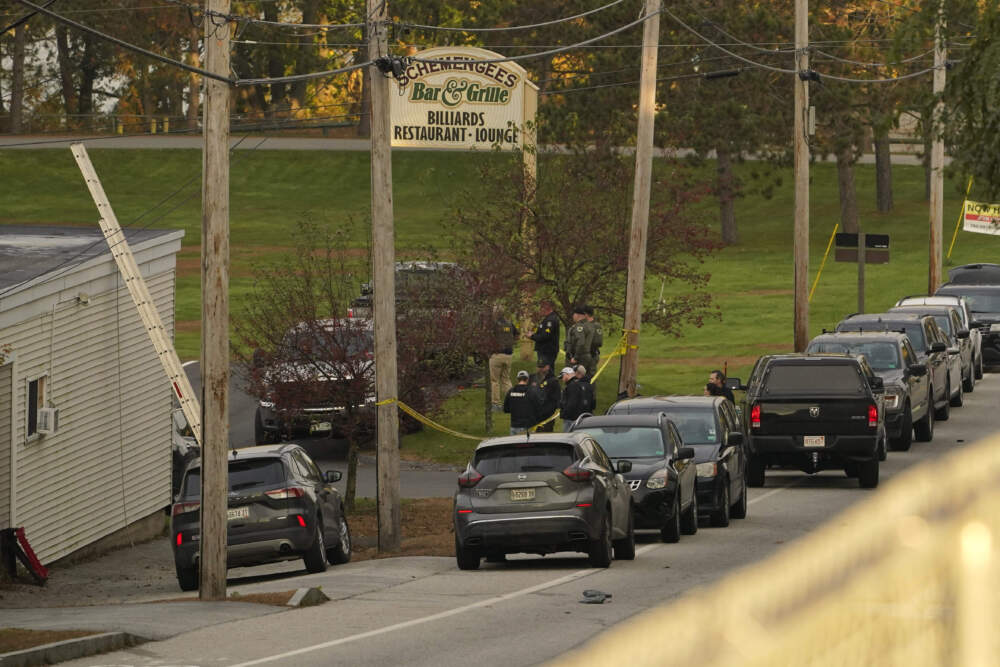 Law enforcement gather Thursday morning outside Schemengee's Bar and Grille in Lewiston, Maine. Residents have been ordered to shelter in place as police continue to search for the suspect of Wednesday's mass shooting at the bar. (Robert F. Bukaty/AP)