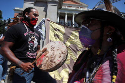 Andre Strong Bear Heart of the Nipmuc Indian Tribe plays a drum during a rally outside the Massachusetts State House in Boston. (Photo by Craig F. Walker/The Boston Globe via Getty Images)