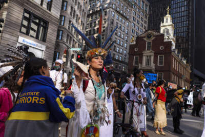 Chali'Naru Dones, with the United Confederation of Taino People, marches past the Old State House while participating in the Indigenous Peoples Day rally and march in Boston on Oct. 10, 2020. (Photo by Erin Clark/The Boston Globe via Getty Images)