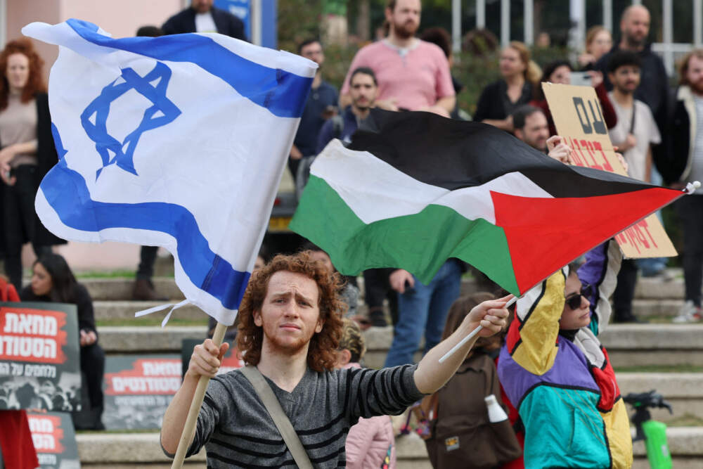 Israeli students hold Palestinian and Israeli flags, during a demonstration against Prime Minister Benjamin Netanyahu's new hard-right government, in Tel Aviv University's campus, on Jan. 16, 2023. (Jack Guez/AFP via Getty Images)