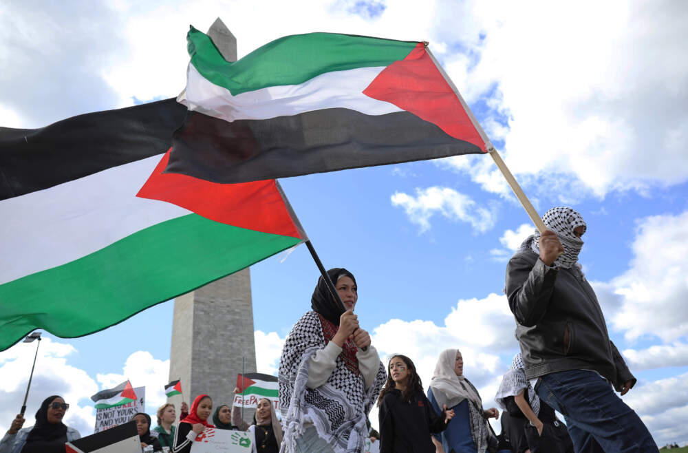 Palestinian protesters carry Palestinian flags as they march by the Washington Monument during a demonstration calling for a ceasefire in Gaza on Oct. 21, 2023 in Washington, DC. (Justin Sullivan/Getty Images)