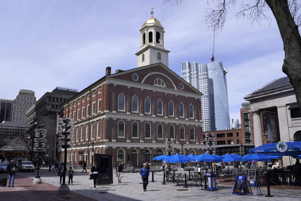 Visitors pass by Faneuil Hall in Boston. (Charles Krupa/AP)
