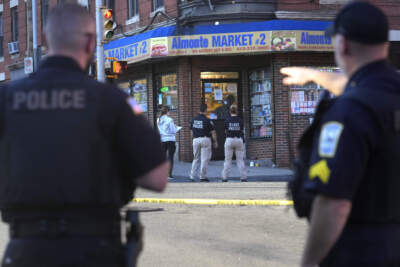 Law enforcement officials investigate the scene where multiple people were shot, Wednesday, Oct. 4, 2023, in Holyoke, Mass. State police say at least three people, including a person riding a bus, were shot Wednesday in Holyoke following a fight on a downtown street. (AP Photo/Steven Senne)