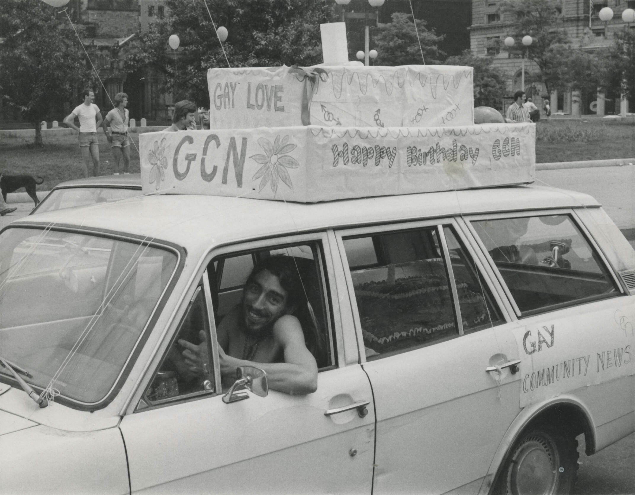 Gay Community News Office Manager Ron Arruda driving a GCN birthday cake in the 1974 Pride parade and celebration in Boston. (Courtesy The History Project)