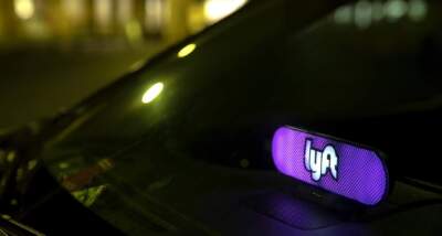 A Lyft stops to collect passengers at Logan Airport. The 2024 ballot in Massachusetts could feature two different questions affecting Uber and Lyft drivers. (Robin Lubbock/WBUR)