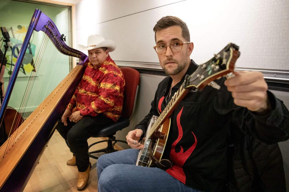 Latingrass singer-songwriters and instrumentalists Larry Bellorín (left) and Joe Troop (right) tune up at the Here & Now studios in Boston. (Robin Lubbock/WBUR)