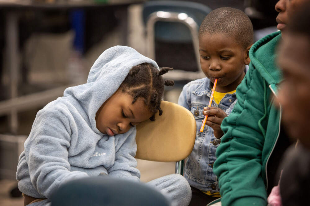 A child catches a few moments of sleep at the Immigrant Family Services Institute, in Mattapan. (Robin Lubbock/WBUR)