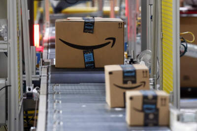 Packages pass through a scanner at an Amazon fulfillment center. (Patrick Semansky/AP)