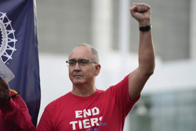 United Auto Workers President Shawn Fain raises his fist at a rally in Detroit on Sept. 15, 2023. (Paul Sancya/AP)