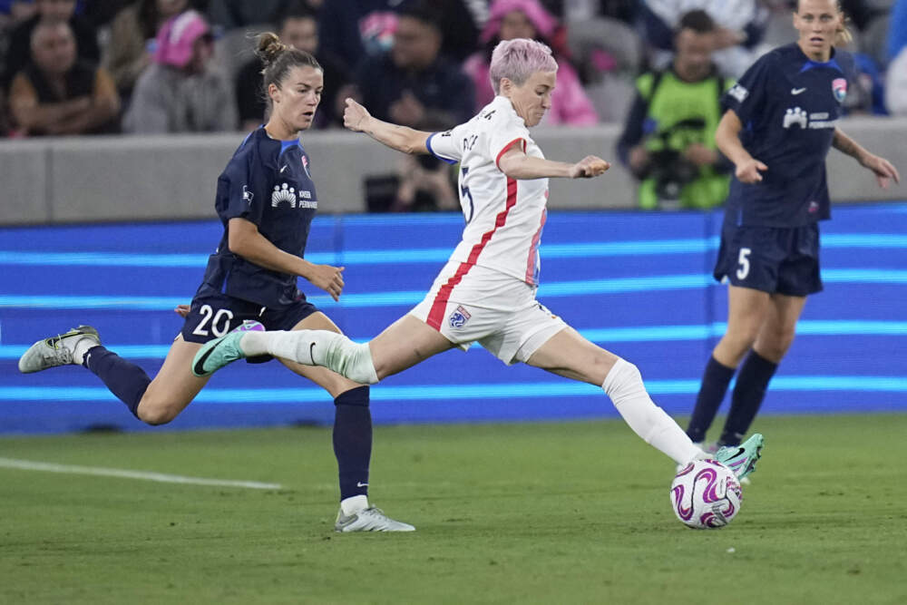 OL Reign forward Megan Rapinoe, center, passes the ball as San Diego Wave defender Christen Westphal defends during the second half of an NWSL semifinal playoff soccer match. (Gregory Bull/AP)