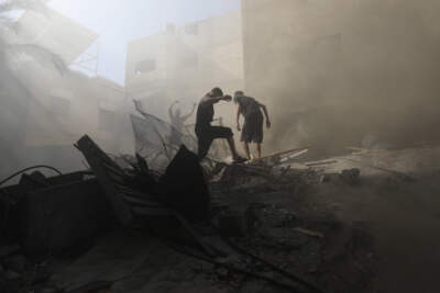 Palestinians look for survivors under the rubble of a destroyed building following an Israeli airstrike in Khan Younis refugee camp, southern Gaza Strip, Monday, Nov. 6, 2023. (Mohammed Dahman/AP)