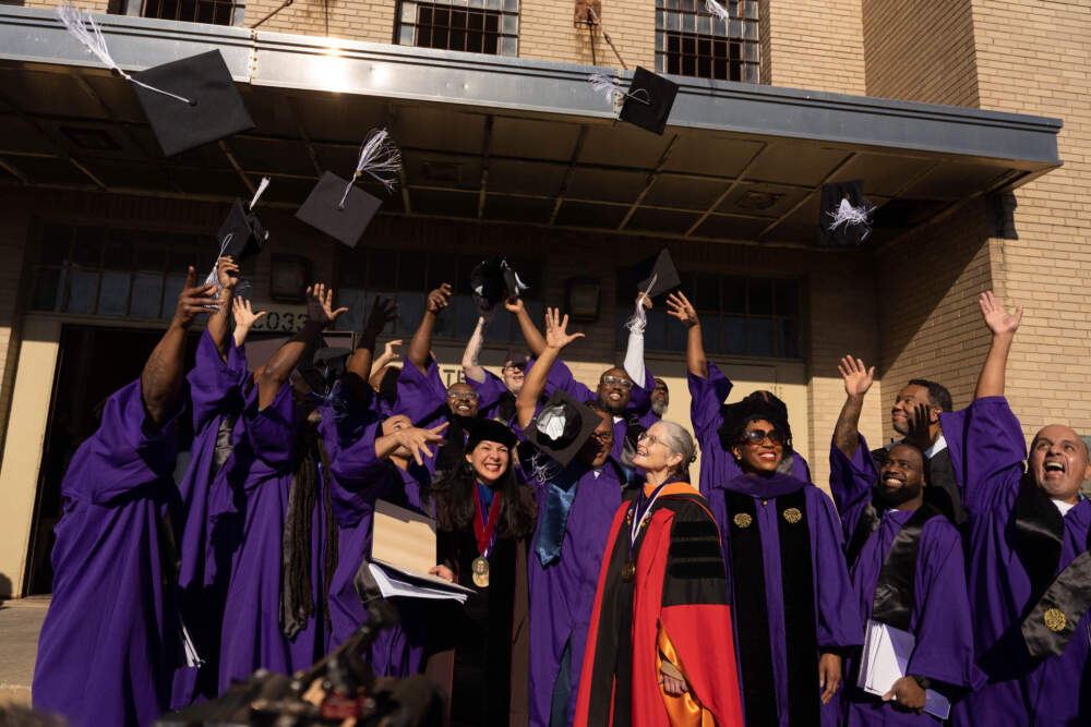 Northwestern Prison Education Program graduates throw their caps in the air. (Courtesy of Northwestern University)