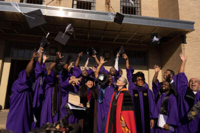 Northwestern Prison Education Program graduates throw their caps in the air. (Courtesy of Northwestern University)