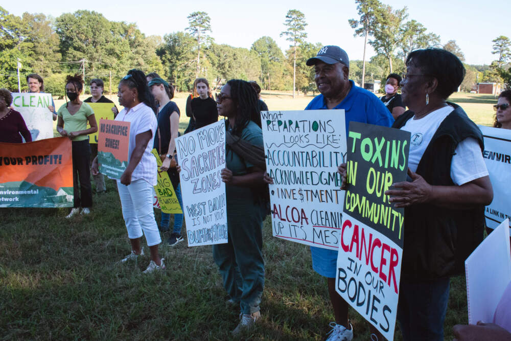 Protesters gather in front of Badin Lake to demand that Alcoa clean up industrial waste from its unlined landfills. (Courtesy of Zachary Turner)