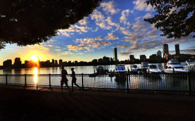 Two people run along the Charles River in Cambridge, Mass. during a sunrise on October 8, 2021. (David L. Ryan/The Boston Globe via Getty Images)