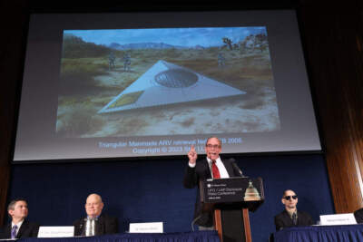WASHINGTON, DC - JUNE 12: Steven Greer, ufologist and founded of the Center for the Study of Extraterrestrial Intelligence and the Disclosure Project, delivers remarks on his UFO and Unidentified Aerial Phenomena (UAP) research under an artist rendering of an incident, during a press conference on June 12, 2023 in Washington, DC. Greer spoke on his archive of research on UFOs consisting of government documents, whistleblower testimony and alleged locations of UFO projects sites. (Photo by Kevin Dietsch/Getty Images)