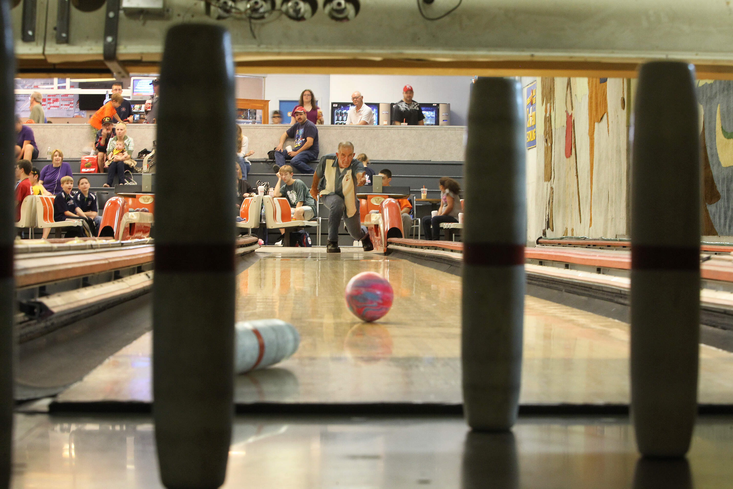 A man bowls at the now-shuttered Pilgrim Lanes in Haverhill. (Stan Grossfeld/The Boston Globe via Getty Images)