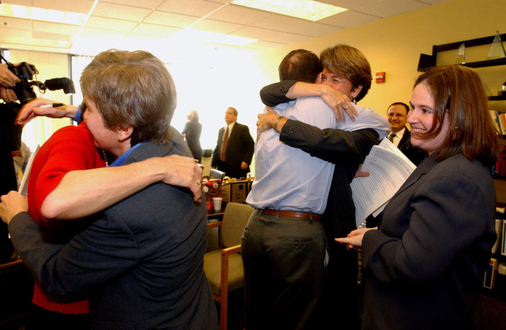 Lawyers and plaintiffs, including Hillary Goodridge, hug at the GLAD headquarters in Boston after hearing the news that the Massachusetts Supreme Judicial Court found the ban on gay marriage was unconstitutional. (Michele McDonald/The Boston Globe via Getty Images)