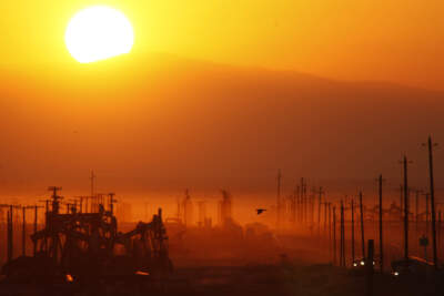 The sun rises over an oil field over the Monterey Shale formation where gas and oil extraction using hydraulic fracturing, or fracking, is on the verge of a boom on March 24, 2014 near Lost Hills, California. (David McNew/Getty Images)