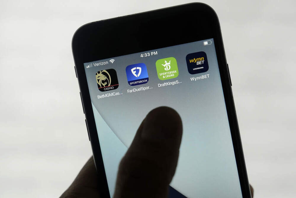 FanDuel, DraftKings and other online gambling apps are displayed on a phone. (Jeff Chiu/ AP)