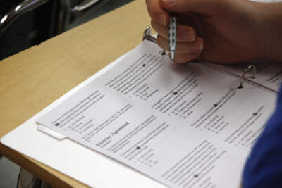 In this 2016 photo, a student looks at questions during a college test preparation class at Holton Arms School in Bethesda, Md. The SAT exam will move from paper and pencil to an exclusively digital format. (Alex Brandon/AP)