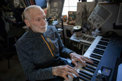 Dr. Stanley Sagov plays a keyboard at his home in Chestnut Hill. (Robin Lubbock/WBUR)