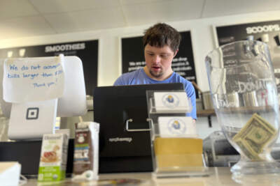 Patrick Chapman, 27, prepares for customers Thursday, March 2, 2023, at The Golden Scoop, an Overland Park, Kan., ice cream and coffee shop that employs workers with developmental disabilities, paying them more than minimum wage. But some disabled workers employed at so-called sheltered workshops are earning far less than minimum wage, an issue that has captured the attention of lawmakers in the state. Disability rights advocates say the practice is discriminatory and more than a dozen states have banned such wages. (Heather Hollingsworth/AP)