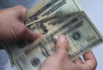 Twenty dollar bills are counted. (Elise Amendola/AP)