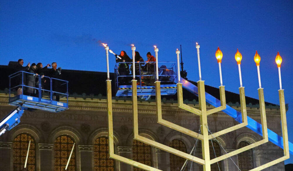 Boston city officials light the giant Copley Square menorah on the last day of Hanukkah in 2021. (Pat Greenhouse/The Boston Globe via Getty Images)