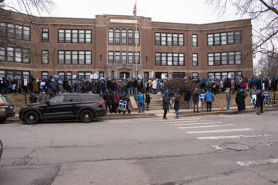 Hundreds of educators attended a rally at the Newton Education Center on Wednesday morning highlighting the need to increase pay for the district's instructional aids. (Meghan Kelly/WBUR)