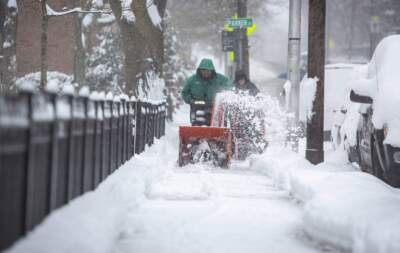 A snowblower clears the sidewalk on Concord Avenue in Cambridge. (Robin Lubbock/WBUR)