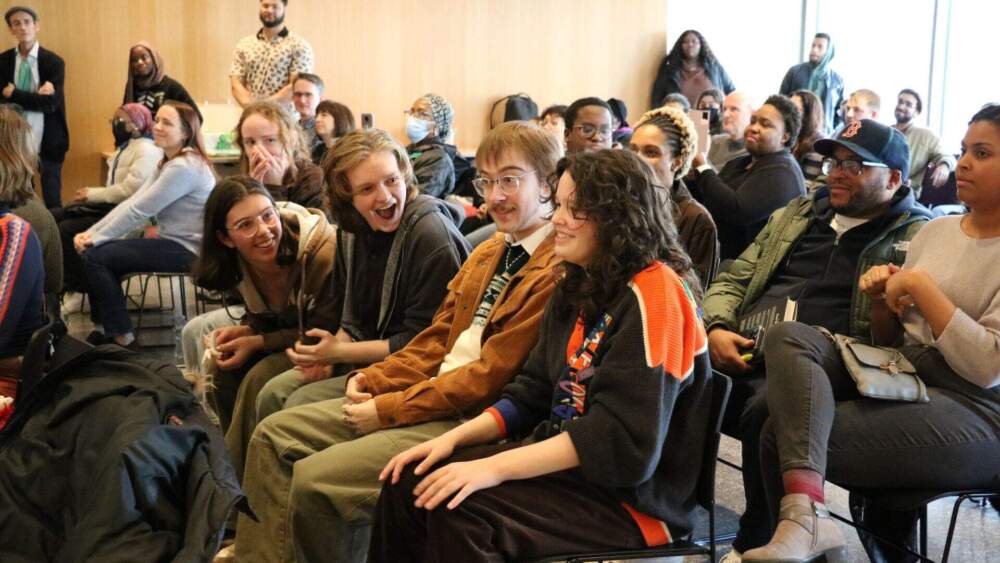 15-year-old Parker-Vincent Alva, seated in the foreground with his hands on his knees, learns he is the city's next youth poet laureate (Courtesy the Mayor's Office of Arts & Culture, City of Boston)