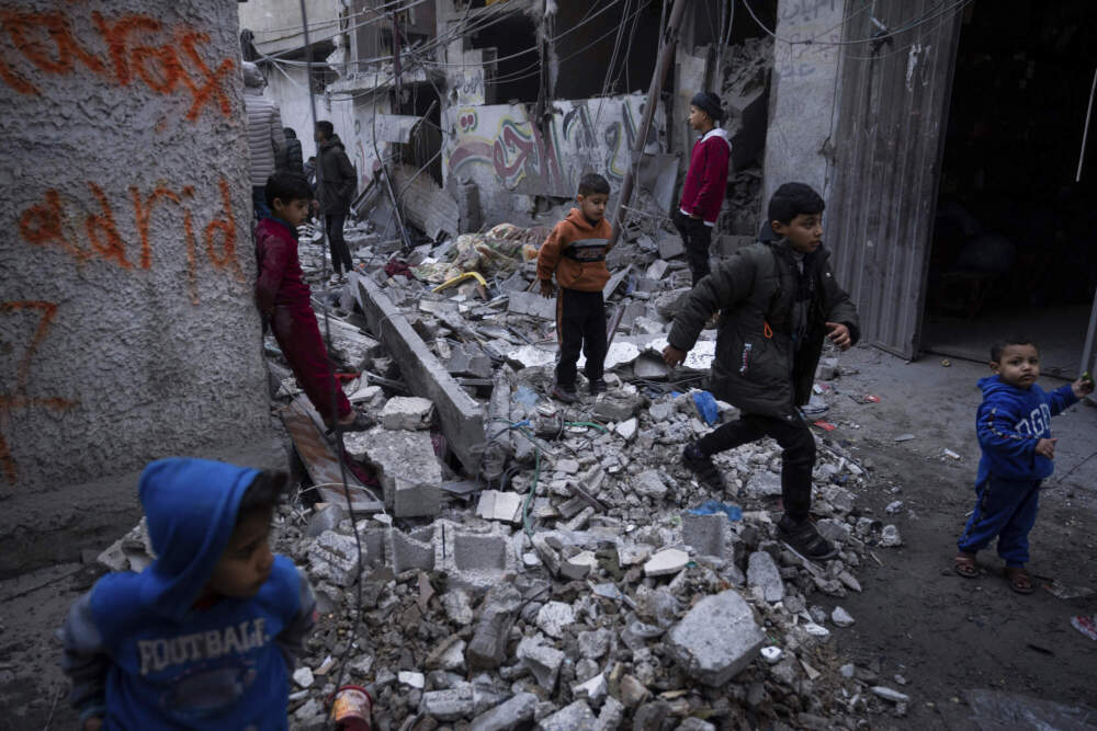 Palestinian children look at the destruction after an Israeli strike in Rafah, southern Gaza Strip. (Fatima Shbair/AP)