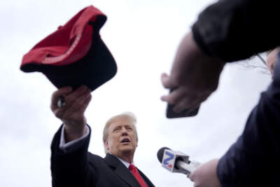 Republican presidential candidate Donald Trump hands off a signed hat during a campaign stop in Londonderry, N.H., Tuesday, Jan. 23, 2024. (Matt Rourke/AP)