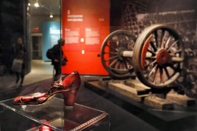A shoe found at Auschwitz, left, and a wheelset from a German freight locomotive are displayed in the &quot;Auschwitz: Not long ago, Not far away&quot; exhibit, at the Museum of Jewish Heritage in New York. (Richard Drew/AP)
