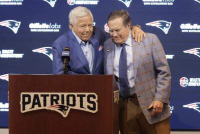 Patriots owner Robert Kraft (left) hugs former head coach Bill Belichick at the end of a press conference announcing Belichick's departure from the team. (Jesse Costa/WBUR)