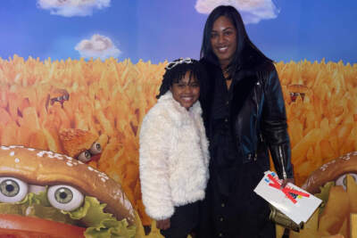 Actress Alexis Tuner, left, and her mom Antoinette Toney, pose in front of a Good Burger 2 movie poster wall. (Courtesy of Antoinette Toney)