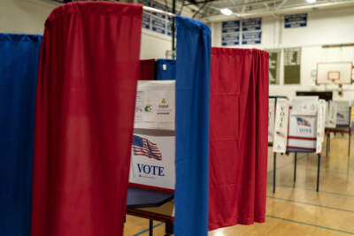 Voting booths are set up in a high school gymnasium in Hollis, N.H. (David Goldman/AP)