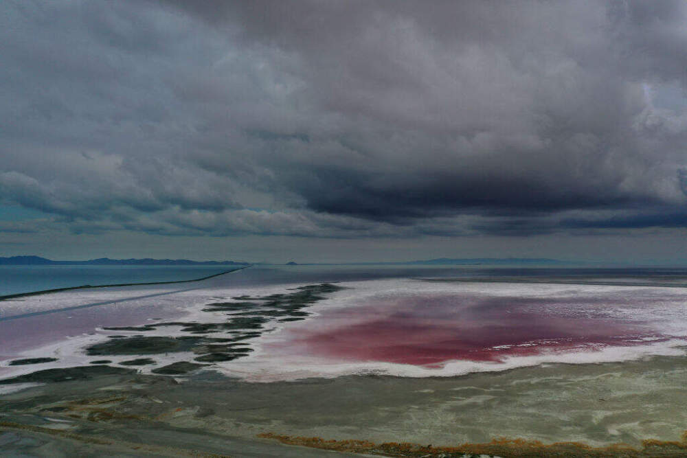In an aerial view, an evaporation pond is pinkish-red due to high salinity levels leaves a crust of salt on the north section of the Great Salt Lake on August 02, 2021 near Corinne, Utah. (Justin Sullivan/Getty Images)