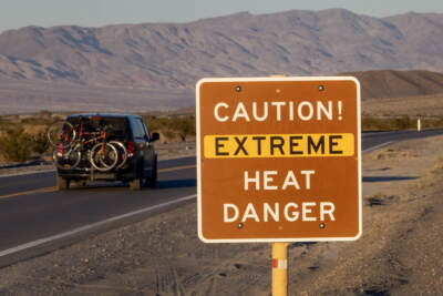 A car passes a sign warning of extreme heat danger on the eve of a day that could set a new world heat record in Death Valley National Park on July 15, 2023 near Furnace Creek, California. Weather forecasts for the following day called for a high temperature of 129º Fahrenheit and possibly as high as 131.  Previously, the highest temperature reliably recorded on Earth was 129.2F (54C) in Death Valley in 2013. A century earlier a high temperature in Death Valley reportedly reached 134F but many modern weather experts have rejected that claim along with other high summer temperatures reported in the region that year.  (David McNew/Getty Images)