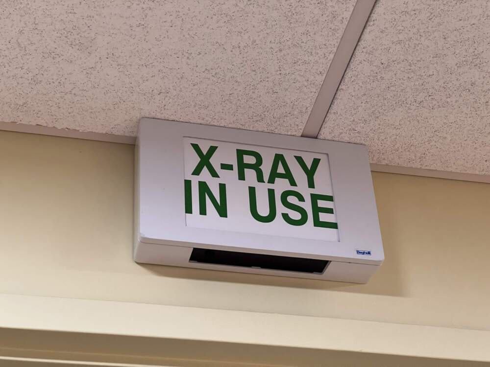 Illuminated 'X-RAY IN USE' sign mounted on a wall. (Photo by Smith Collection/Gado via Getty Images)