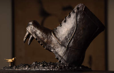 The boot features the fangs and snout of a Russian bear.  Nancy Schon, the 95-year-old sculptor best known for the iconic &quot;Make Way for Ducklings&quot; statue in the Boston Common, has created a new piece commenting on the horror in Ukraine. It depicts a Russian boot about to step down on a nightingale, the national bird of Ukraine. (Lane Turner/The Boston Globe via Getty Images)
