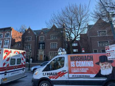 A van proclaiming that Rabbi Menachem Mendel Schneerson will return as the messiah is parked in front of 770 Eastern Parkway, the headquarters of the Chabad Lubavitch movement. (Grace Tatter)