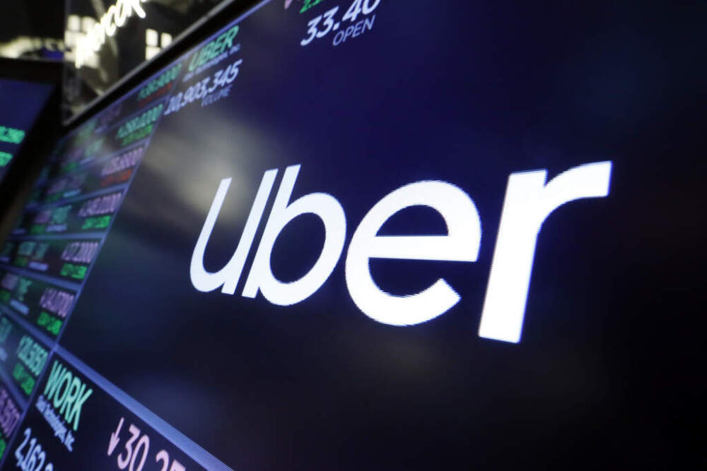 The logo for Uber appears above a trading post on the floor of the New York Stock Exchange. (Richard Drew/AP)