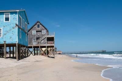 The threatened oceanfront structures of Ocean Dr. sit seaward of the dune and vegetation line. (Zachary Turner/WUNC)