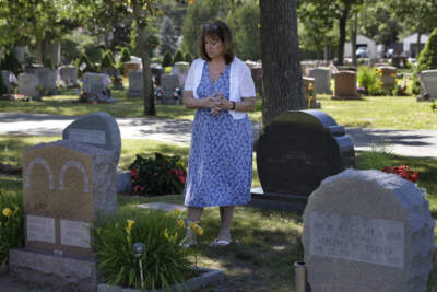 In this 2018 file photo, Cheryl Juaire, of Marlborough, stands at her son's grave, in Chelmsford. Juaire lost her 23-year-old son to an overdose after he became addicted to prescription painkillers. (Steven Senne/AP)