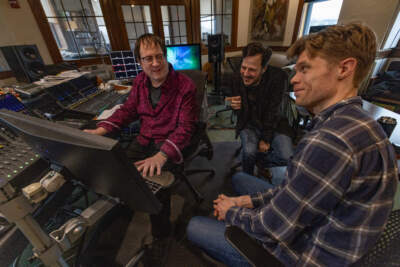 Recording engineer John Weston, Composer Mehmet Ali Sanlikol and producer Jesse Lewis listen to a track from their Grammy-nominated recording &quot;A Gentleman of Istanbul” in the studio at Futura Productions in Roslindale. (Jesse Costa/WBUR)