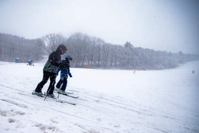 Skiers head to the chair lift at Blue Hills Ski Area in Canton during today’s nor’easter. (Jesse Costa/WBUR)