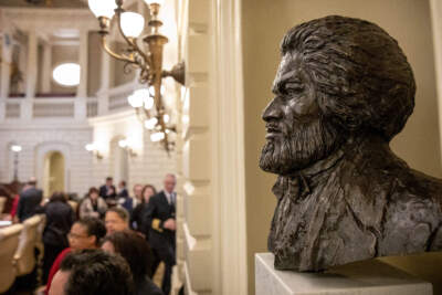 The newly installed bust of Frederick Douglass looks out across the Massachusetts State House Senate Chamber. (Robin Lubbock/WBUR)